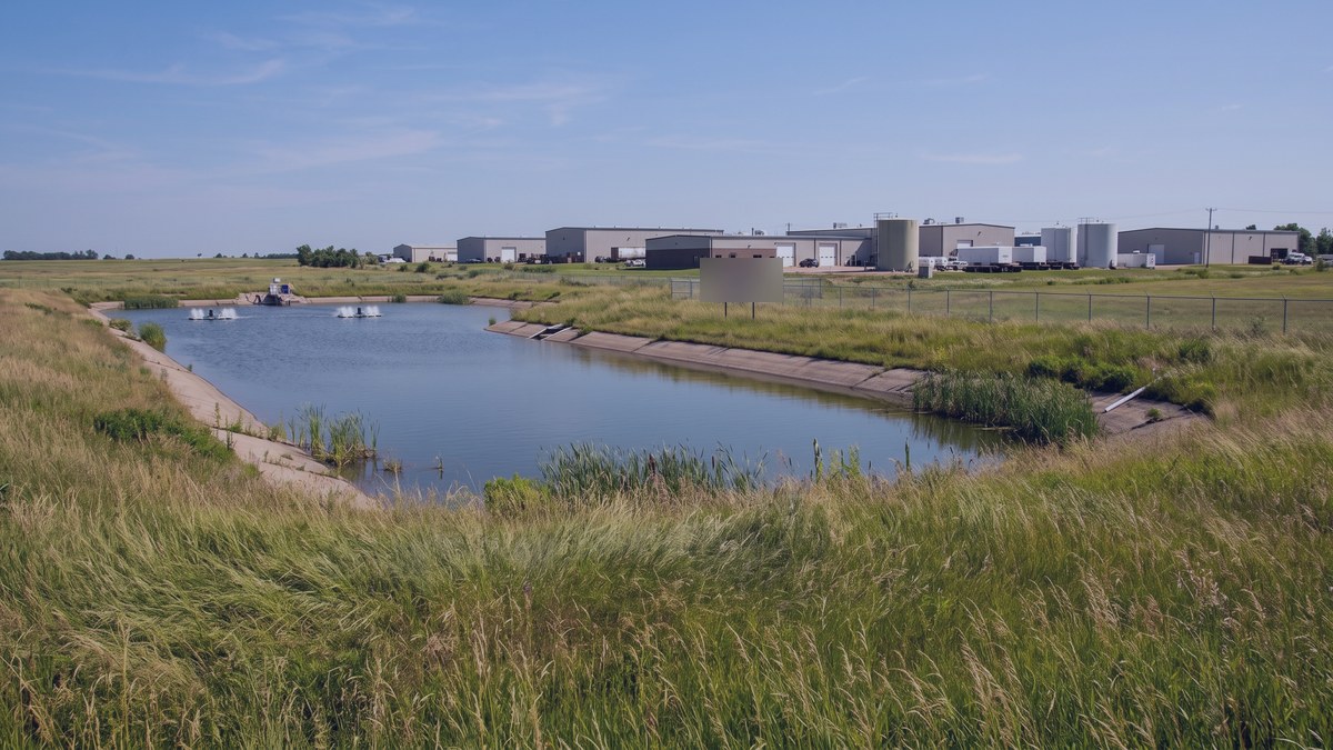 Water reclamation pond beside a data center construction site on the high plains